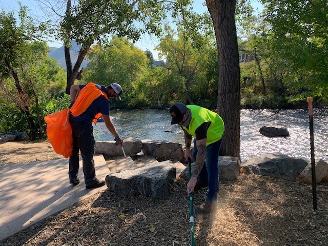 employees cleaning river bank 