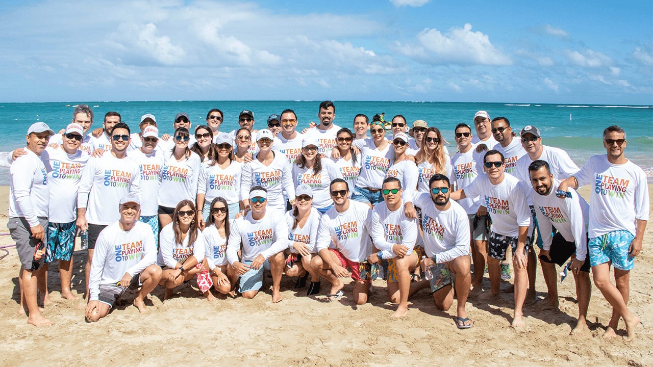Group on a beach wearing matching shirts