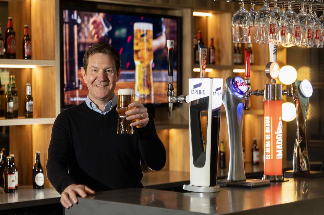 Simon Kerry stands behind a Carling pump