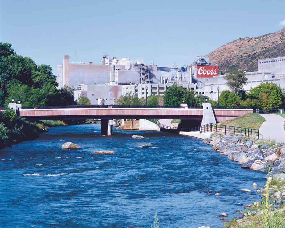 Golden Brewery building beside flowing river